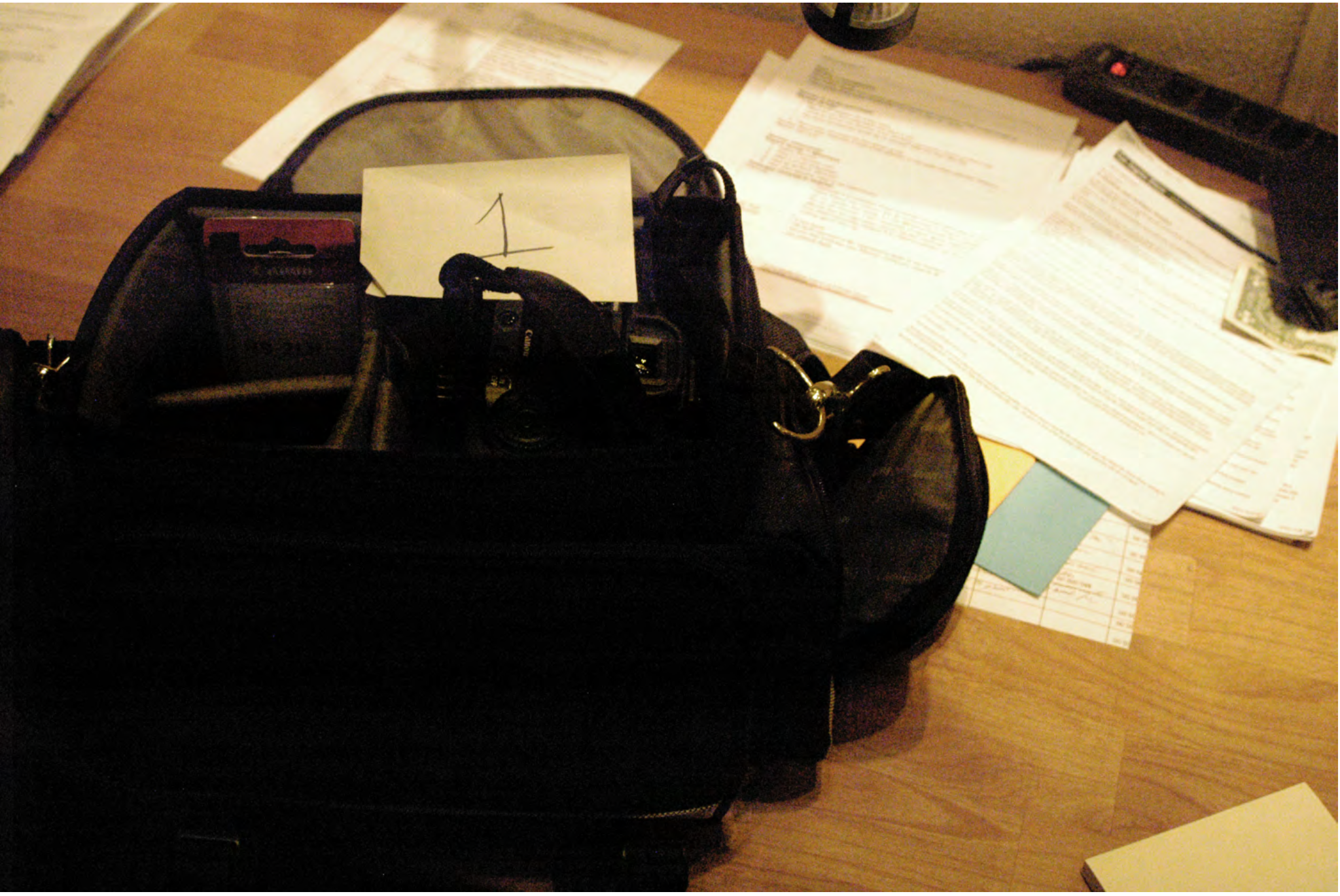 FBI search photo of Item 1 staged on the desk &mdash; the camera is still not visible inside the open bag